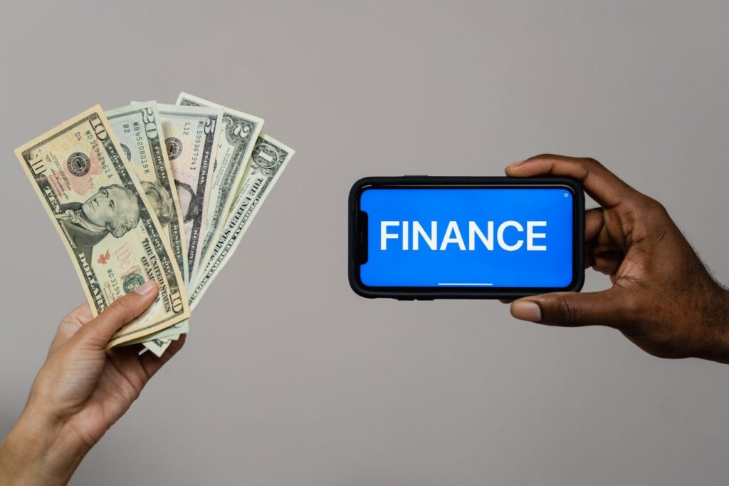 The Art of Drawing Readers In: Your attractive post title goes here Image depicting currency and finance concept with hands holding cash and a smartphone.